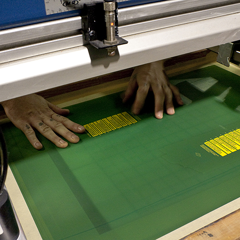 Here is our press operator setting up a screen for printing.